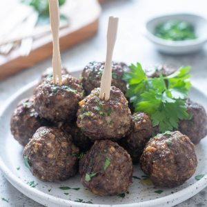 Air fryer meatballs on a plate with parsley