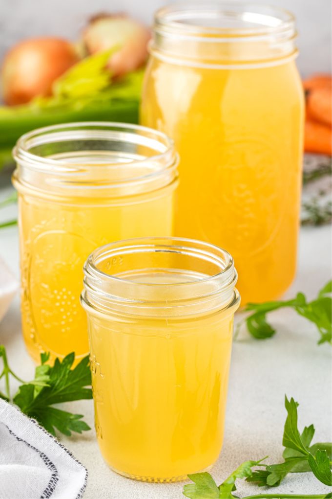 Chicken stock stored in various sized jars
