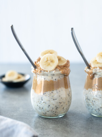 Spoon buried in jar of peanut butter overnight oats