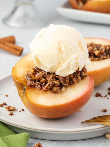 Baked apples cut on a plate with ice cream