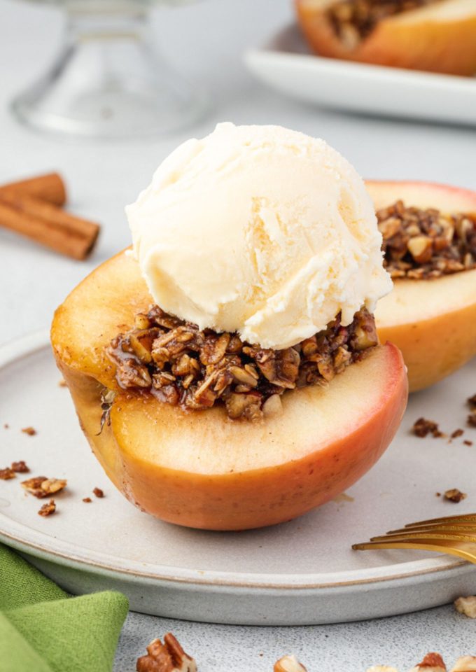 Baked apples cut on a plate with ice cream