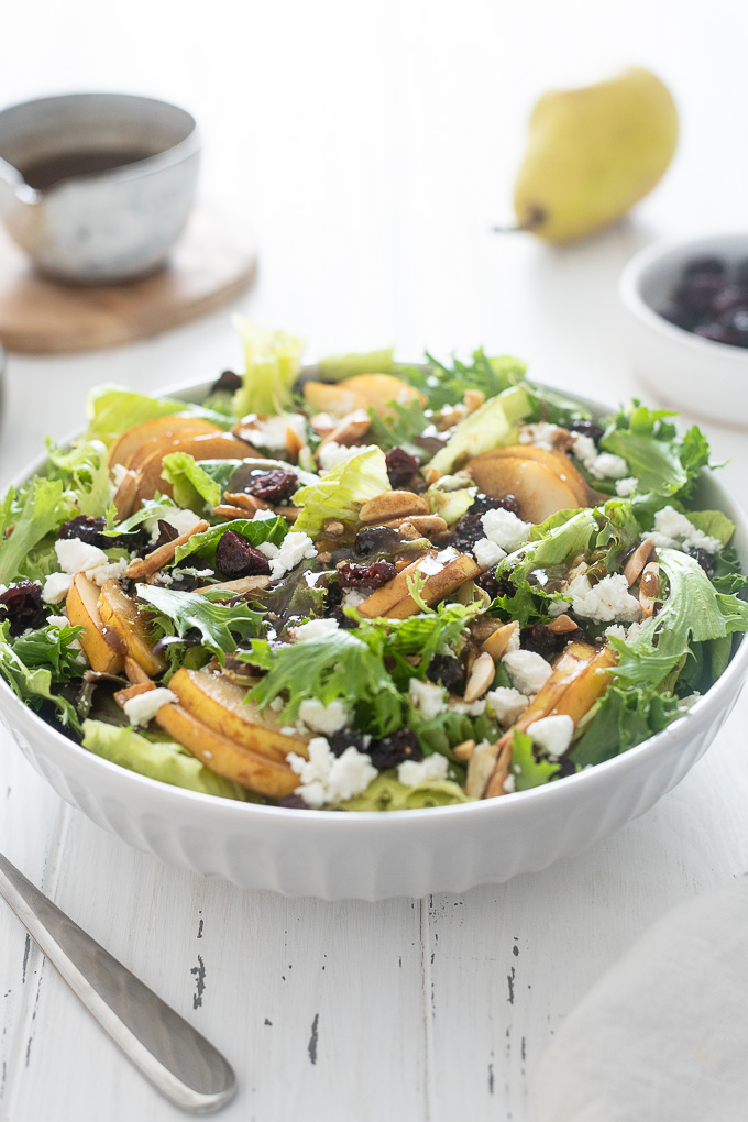 Pear salad with feta in a white bowl