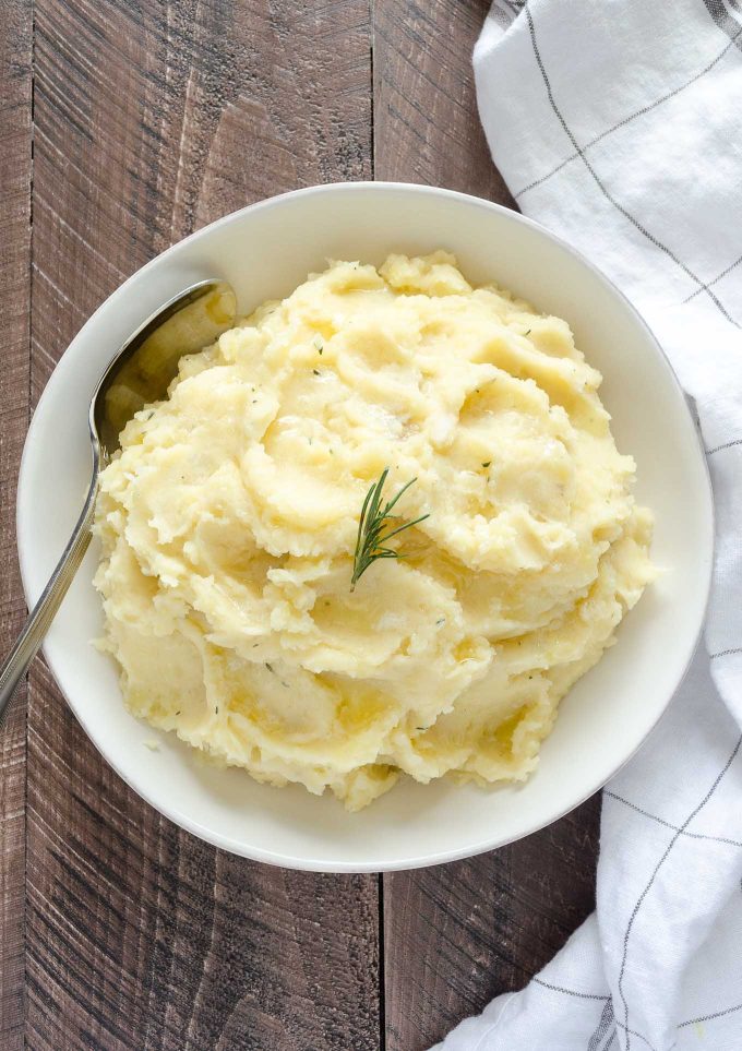 Buttermilk mashed potatoes in a bowl with rosemary