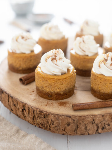 Mini pumpkin cheesecake on a wood serving platter
