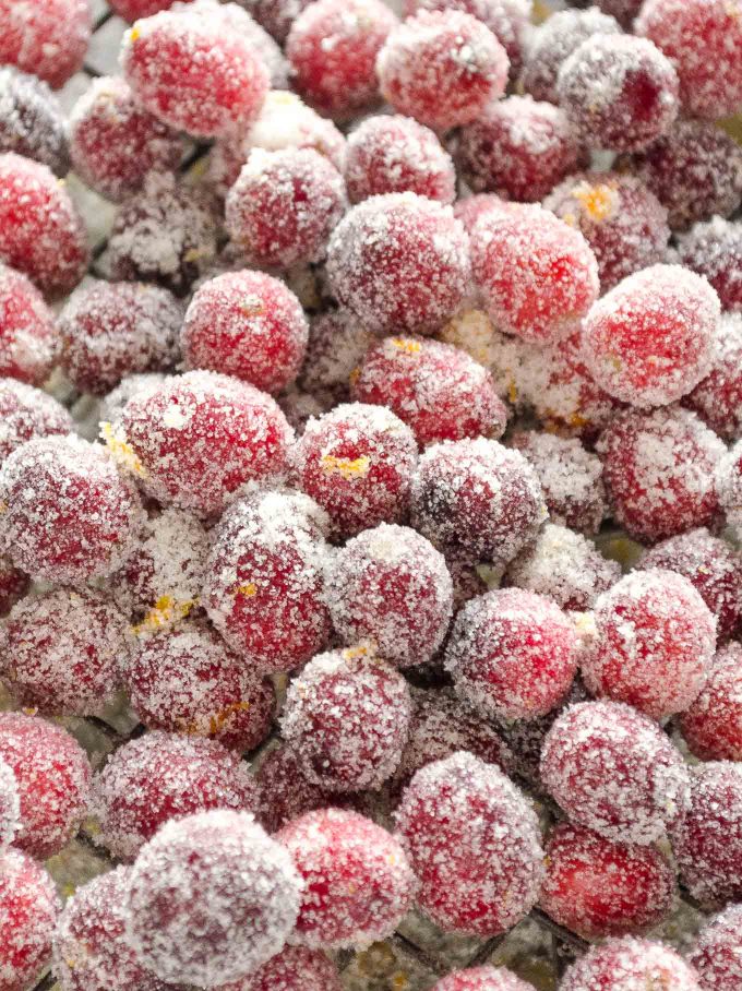 Sparkling Sugared Cranberries piled on a wire rack