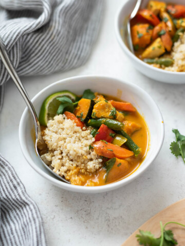 Thai pumpkin curry in a bowl with spoon buried inside