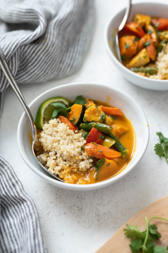 Thai pumpkin curry in a bowl with spoon buried inside