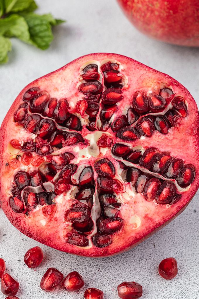 Half of a pomegranate with arils around it