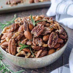 Roasted nuts in a bowl with rosemary