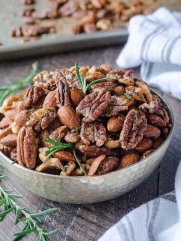 Roasted nuts in a bowl with rosemary