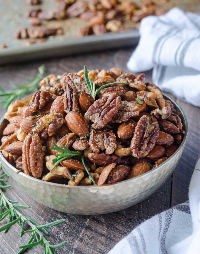 Roasted nuts in a bowl with rosemary