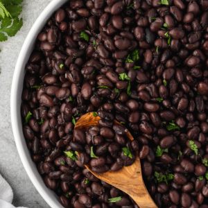 Instant pot black beans in a bowl with a spoon