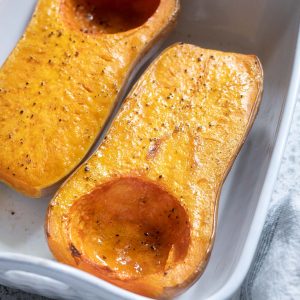 Roasted whole butternut squash in a baking dish