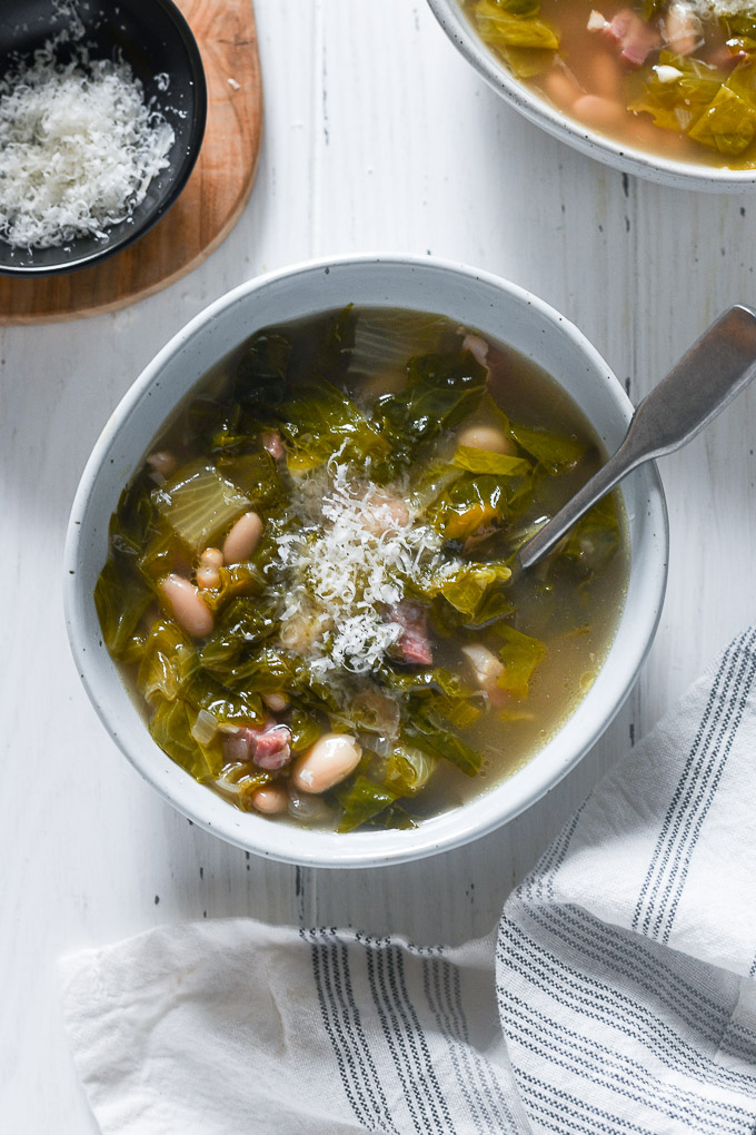 Escarole soup with parmesan cheese on top