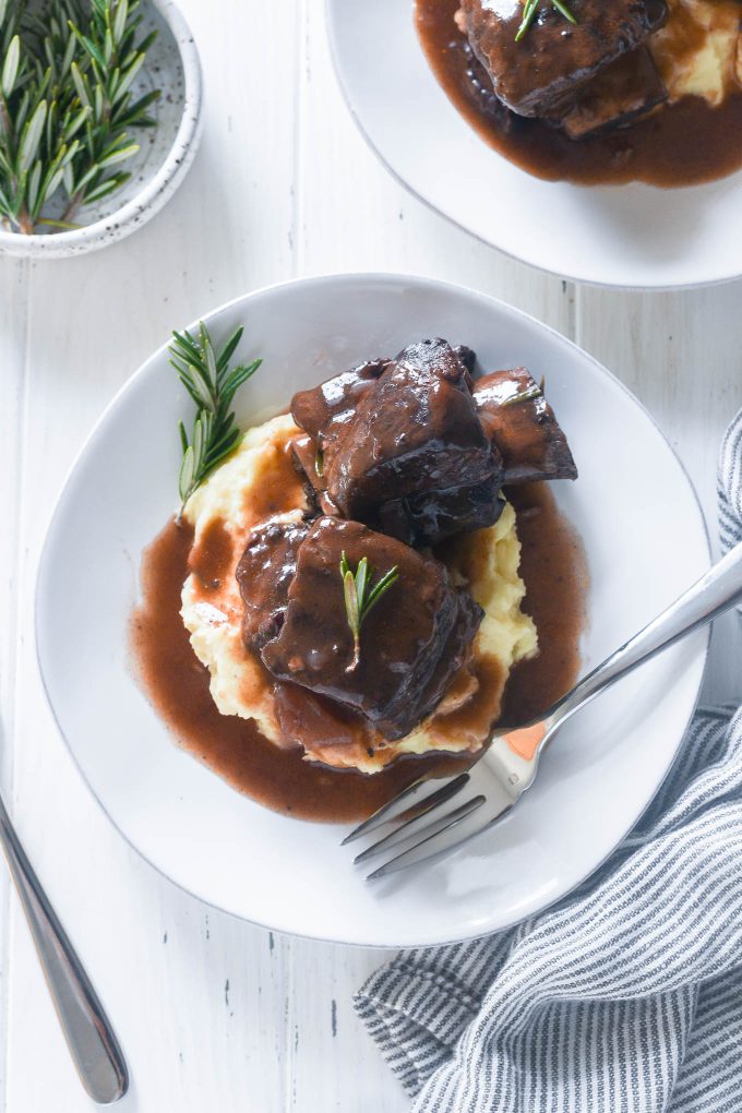 Red wine braised short ribs on a plate with sauce mashed potatoes