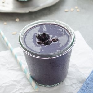 Blueberry banana oat smoothie with berries on top