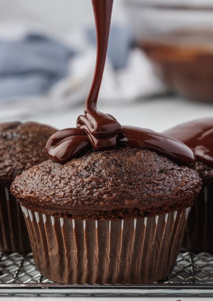 Chocolate ganache drizzling over a cupcake