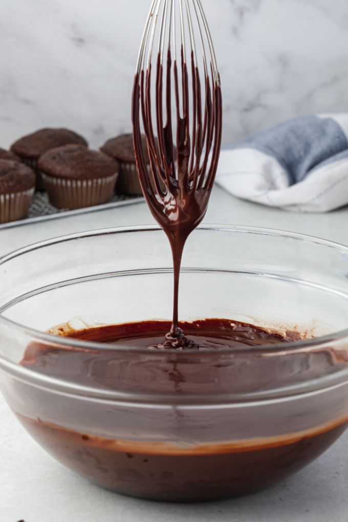 Chocolate ganache drizzling off of a whisk