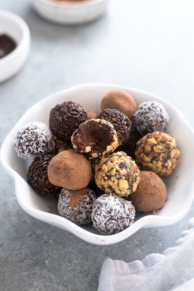 Dark chocolate truffles with bite out of top truffle