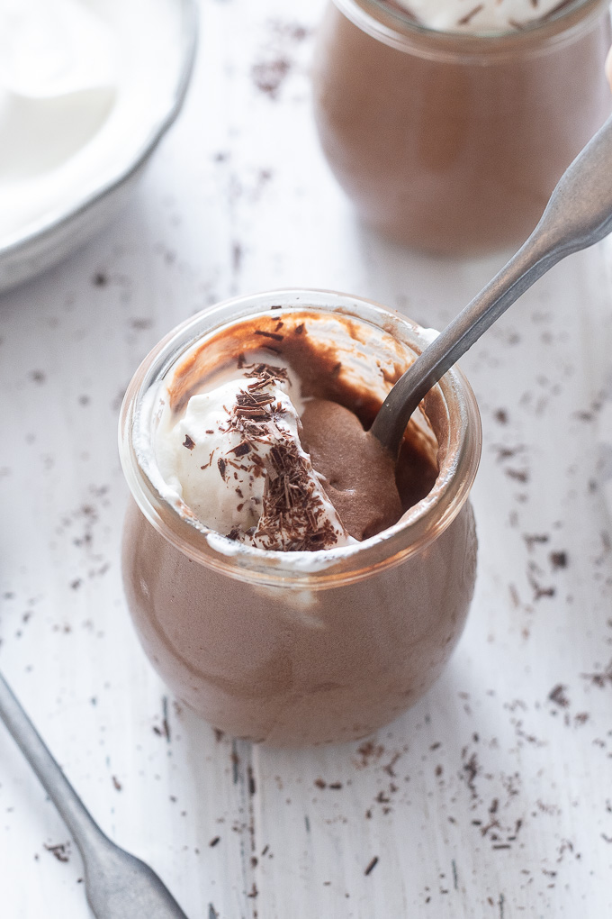 Jar of chocolate mousse with spoon buried inside