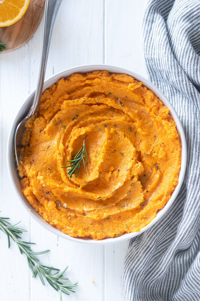 Mashed sweet potatoes with rosemary sprig on top