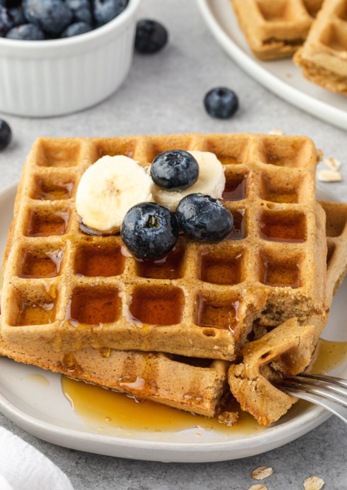 Oat waffles on a plate with banana and blueberries