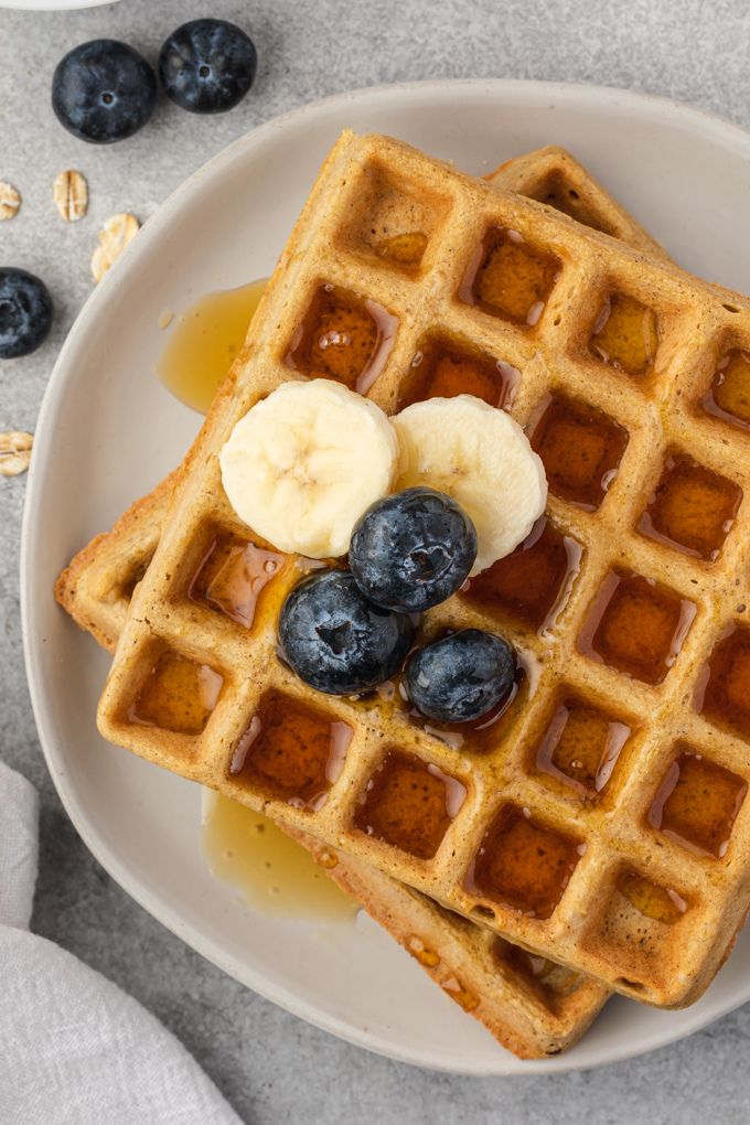 Oat waffles topped with banana, blueberries and syrup