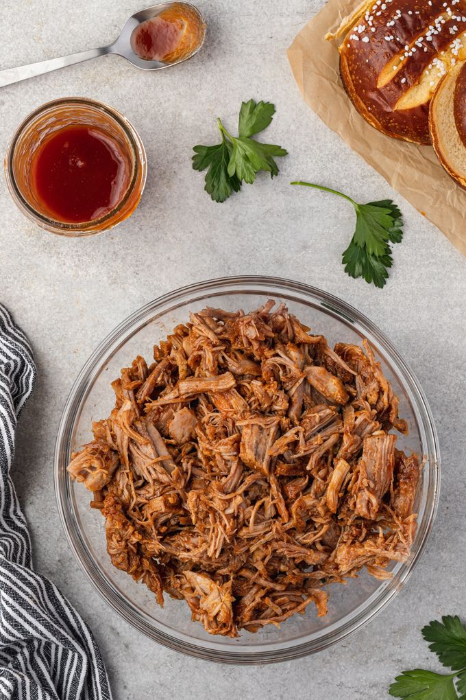 Instant pot pulled pork in mixing bowl with bbq sauce