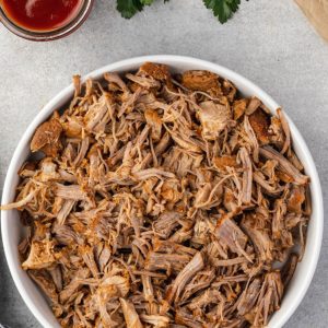 Instant pot pulled pork in a white bowl