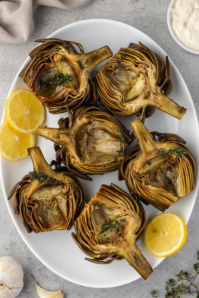 oven roasted artichokes on a serving platter
