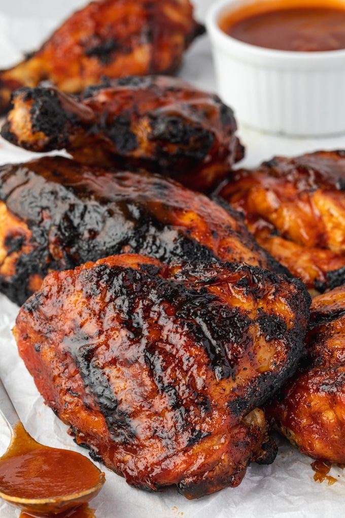 Grilled barbecue chicken on a platter with sauce