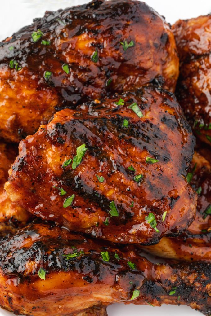 Grilled bbq chicken on a platter with parsley