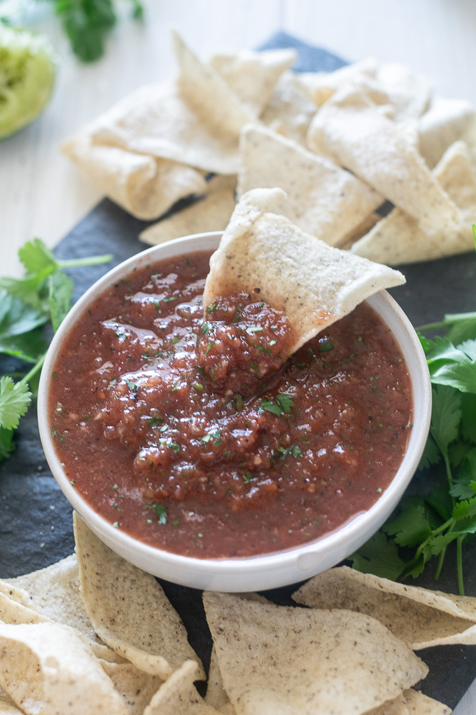restaurant style salsa with chip dipped into the center