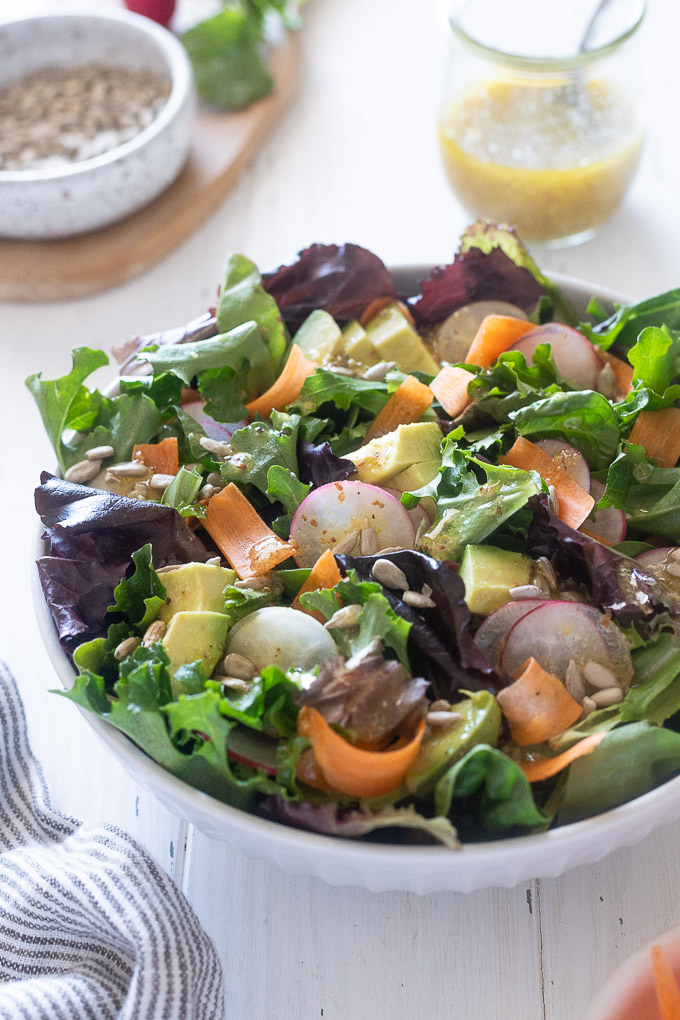 spring mix salad topped with honey mustard dressing