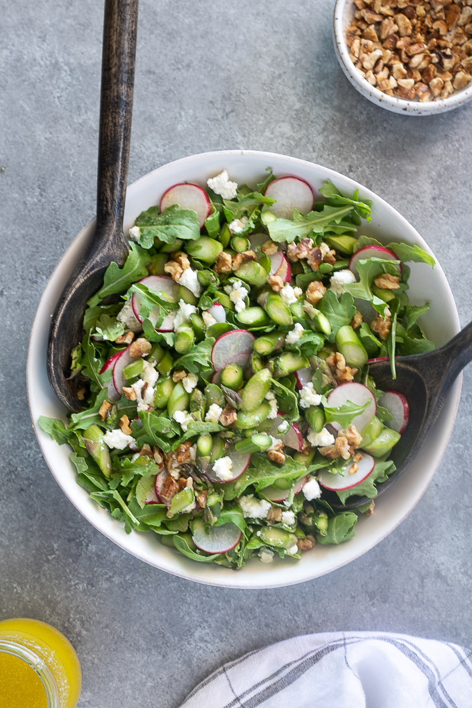 Raw asparagus salad tossed with arugula and goat cheese