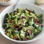 Broccoli salad with bacon in a bowl with serving spoon