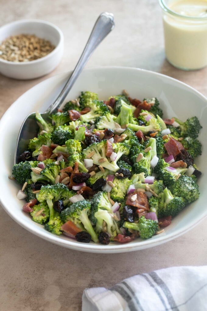Broccoli salad with bacon in a bowl with serving spoon