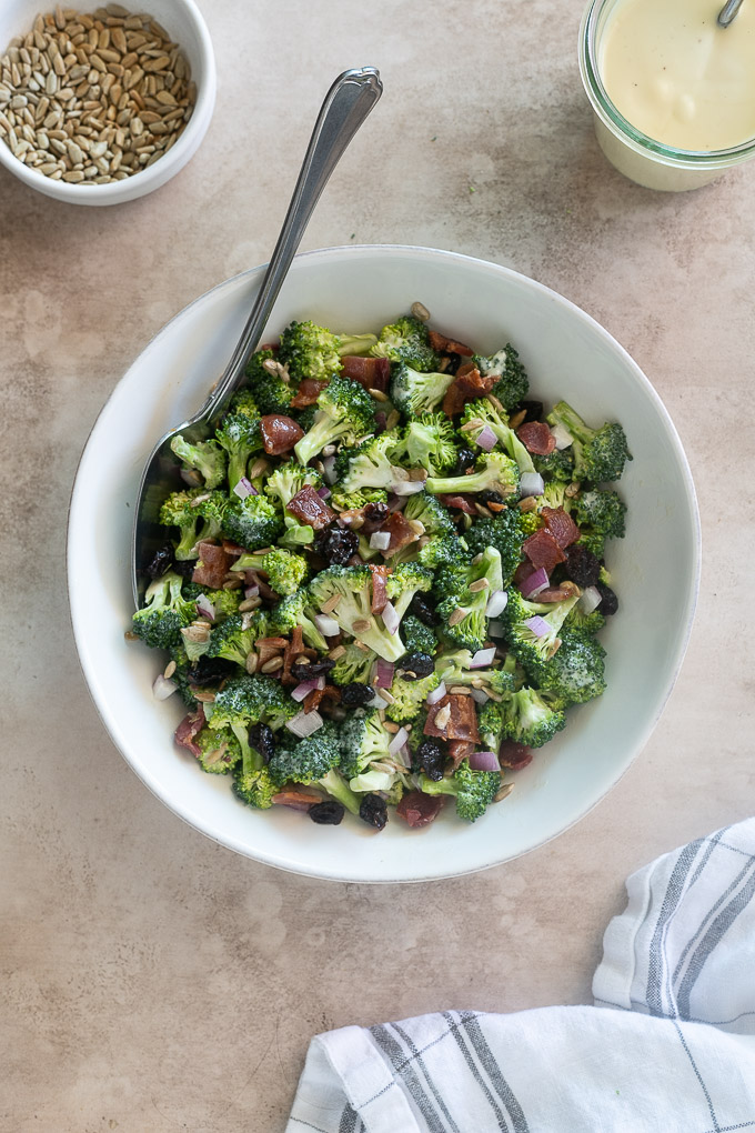 Broccoli salad with a serving spoon digging in