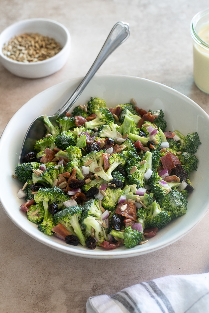 Easy broccoli salad in a bowl with a serving spoon