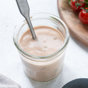Burger sauce in a jar with a spoon buried inside