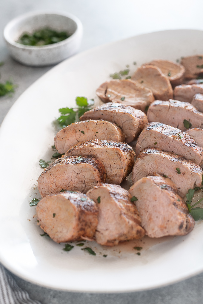 Grilled pork tenderloin slices on a platter