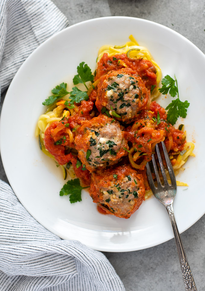 Baked turkey meatballs on a plate over zoodles
