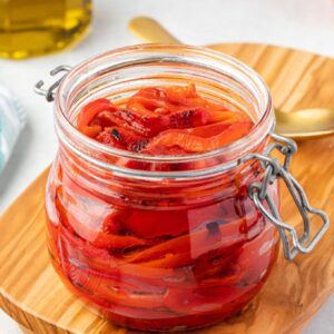 Roasted red peppers in a jar with olive oil