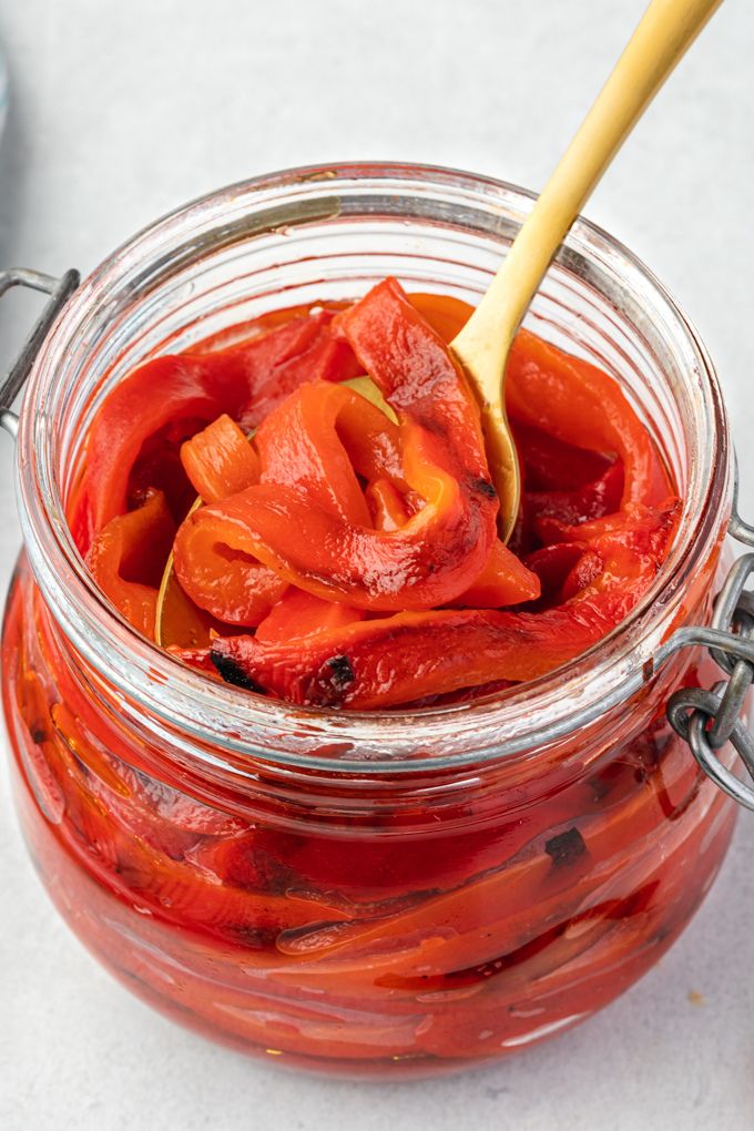 Oven roasted red peppers in a jar with olive oil