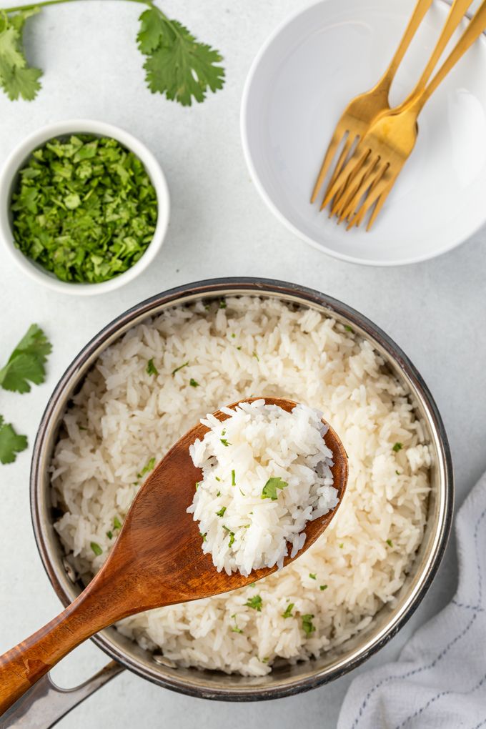 Coconut milk rice in a pot with a spoon