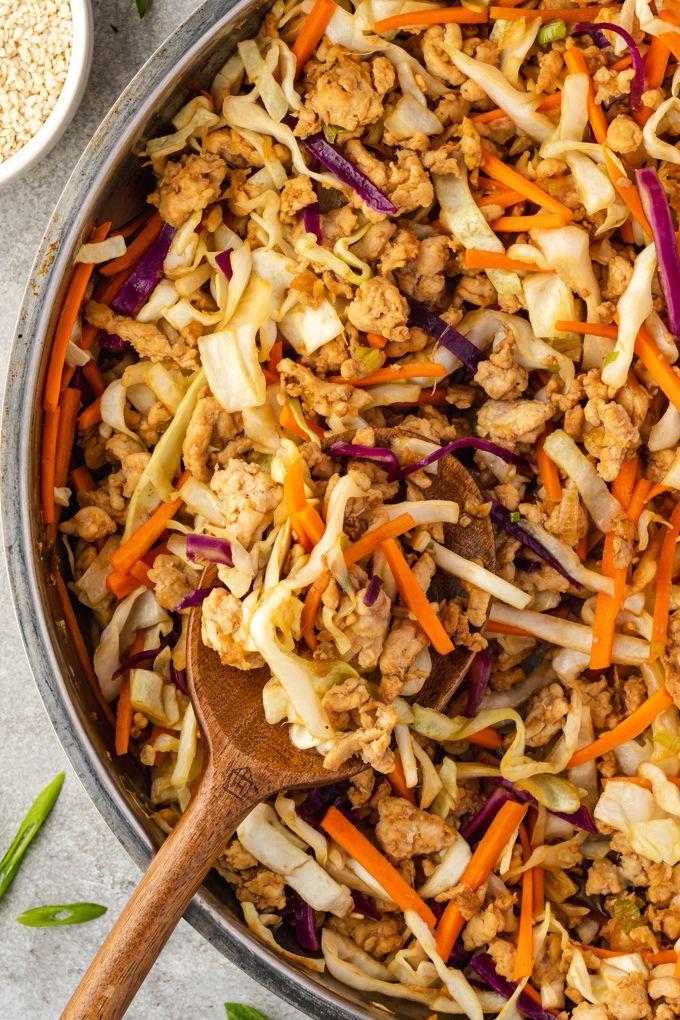 Egg roll in a bowl in a skillet with wooden spoon