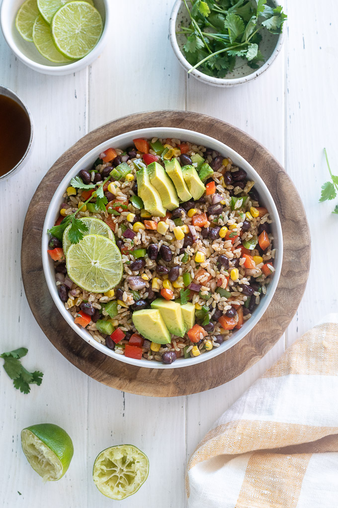 Southwest brown rice salad in a bowl with lime and avocado