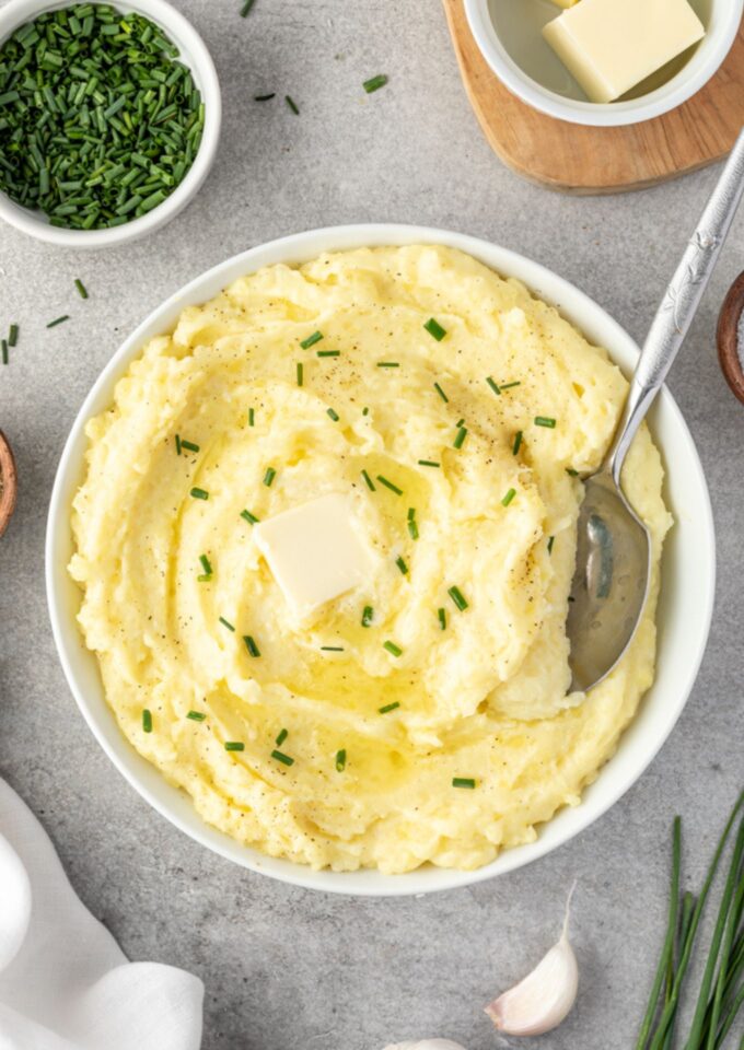 Yukon gold mashed potatoes in a bowl with serving spoon