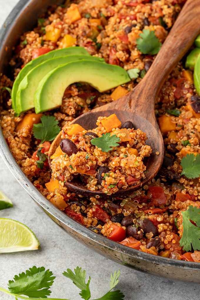 Wooden spoonful of Mexican quinoa with cilantro and avocado
