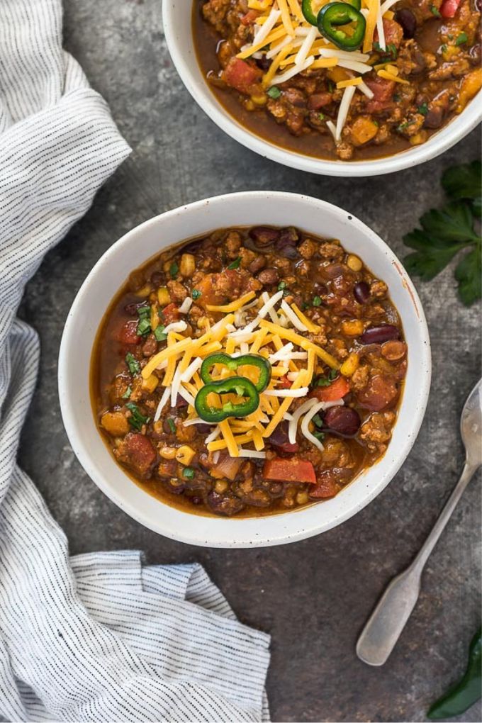 Pumpkin chili in a bowl with cheese and jalapeno
